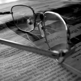 Glasses resting on newspaper